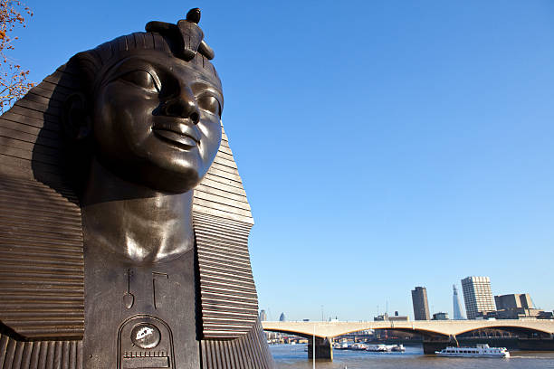 One of two Sphinx guarding Cleopatra's Needle on Victoria Embankment in London England UK erected in 1878 and is a popular tourist travel destination attraction landmark, stock photo image