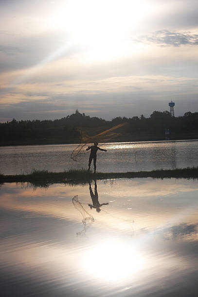 istock Man throwing fishing net during sunset at  Ratchaburi Thailand 178475935