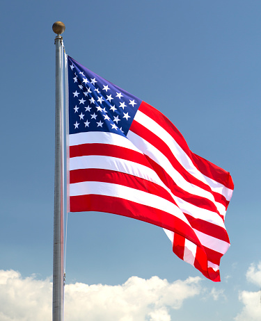 American flag is waving in blue sky. There are fifty (50) states and Washington D.C. The last two states to join the Union were Alaska (49th) and Hawaii (50th). Both joined in 1959. 