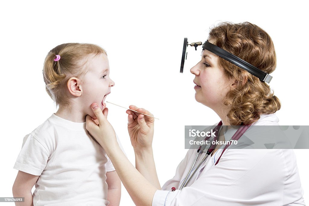 doctor examining baby girl doctor examining baby on white background Adult Stock Photo