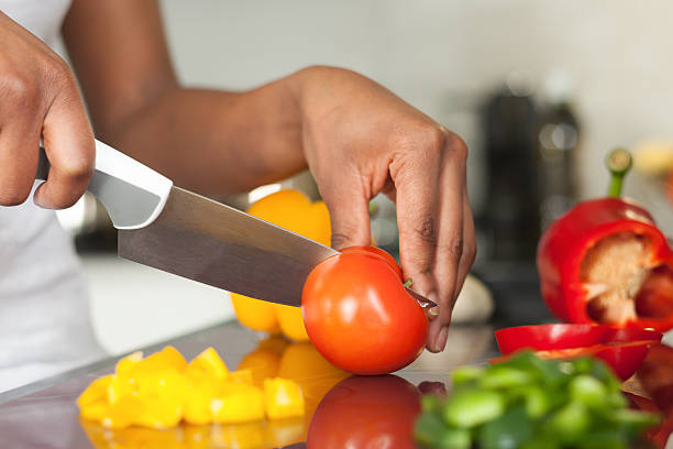 istock Prep cook slicing tomato and peppers 178476825