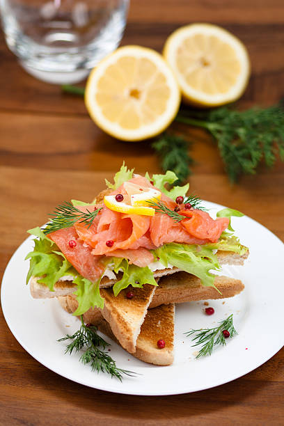 lunch - smoked salmon sandwich with fresh lemon stock photo