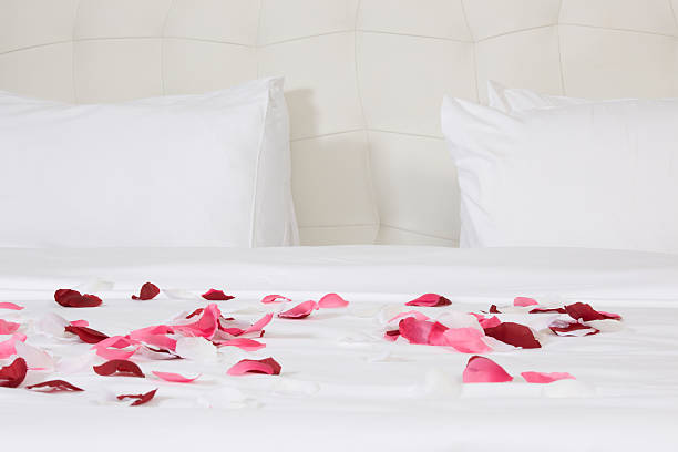 istock hotel room with big bed and red flowers 178476939