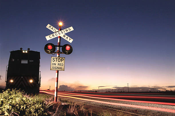 Rural Train Crosssing Light painting of a rural sugar cane train railway crossing. crossing sign stock pictures, royalty-free photos & images