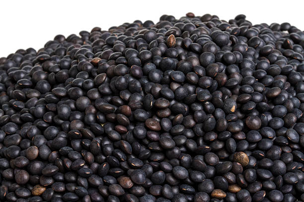 istock Heap of black lentil isolated on white 178477336
