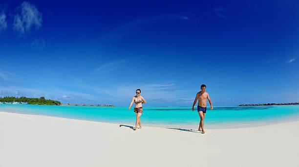 istock happy young  couple enjoying summer on beach 178478066