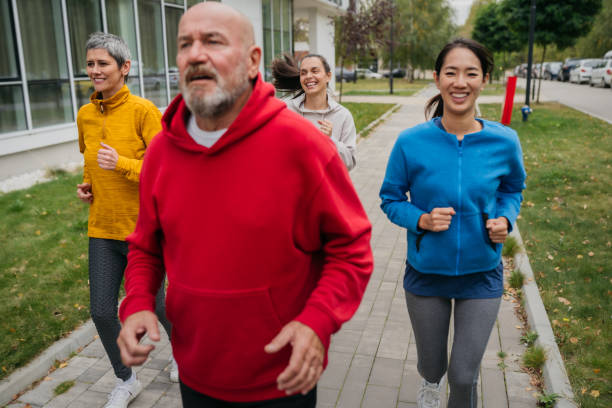 istock Mature and senior people jogging at the park 1784782638