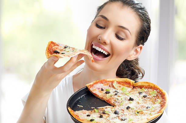 delicious pizza Girl eating a delicious pizza beautiful women giving head stock pictures, royalty-free photos & images
