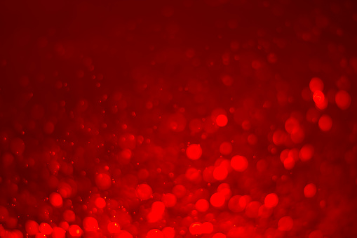 Red glitter vintage lights background. White bokeh on red background. Red heart boked