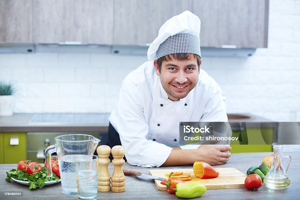 Happy chef Portrait of happy man in cook uniform looking at camera Adult Stock Photo