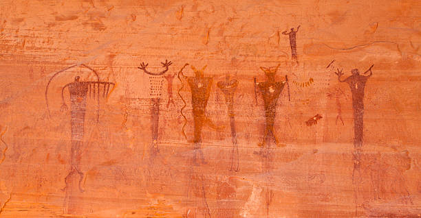 Untouched life-sized Barrier Canyon Style pictographs remain on the vertical wall of sandstone rock after many hundreds perhaps thousands of years in the Glen Canyon National Recreation Area in southern Utah. The pictographs were made by the Desert Archaic Culture which used the area from about 8000 B.C. to 400 A.D.