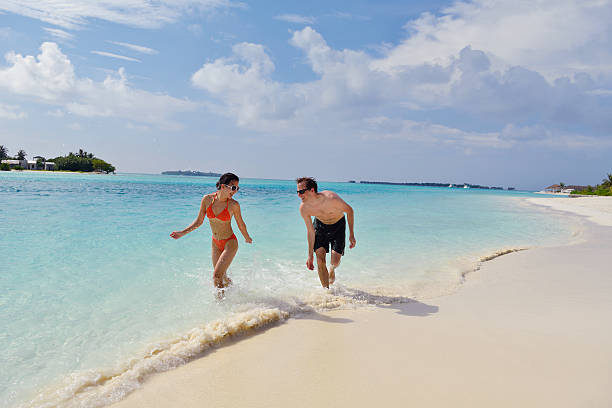 istock happy young couple have fun on beach 178480272