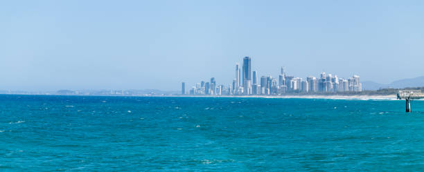 Surfers Paradise skyline in distance along famous holiday destination beach.
