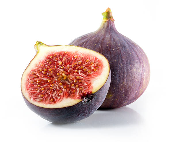 A halved and whole fig isolated on a white background Fresh figs isolated on white fig photos stock pictures, royalty-free photos & images