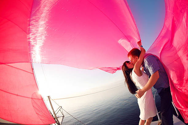 couple under the sail stock photo