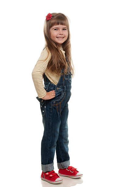 istock cute little girl posing in studio and smiling 178481559