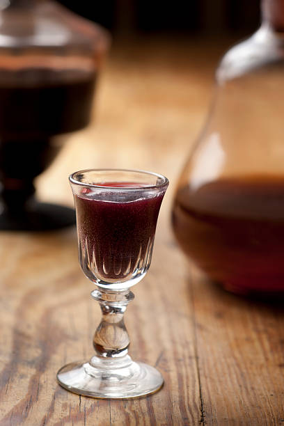 Glass of liqueur. Old antique carafe and glass of liqueur.  Traditional Polish aged nalewka. nalewka stock pictures, royalty-free photos & images