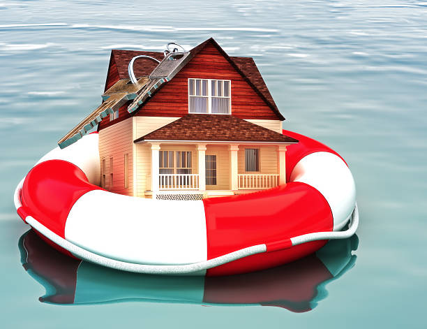 Home floating on a life preserver. Symbolizing a recovering housing economy, flood protection, home salvage , bailout, ect.  foreclosure photos stock pictures, royalty-free photos & images