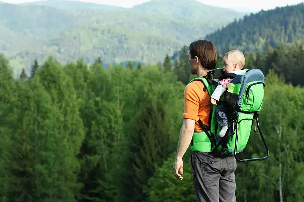 Photo of Father with 1 year old son in baby carrier