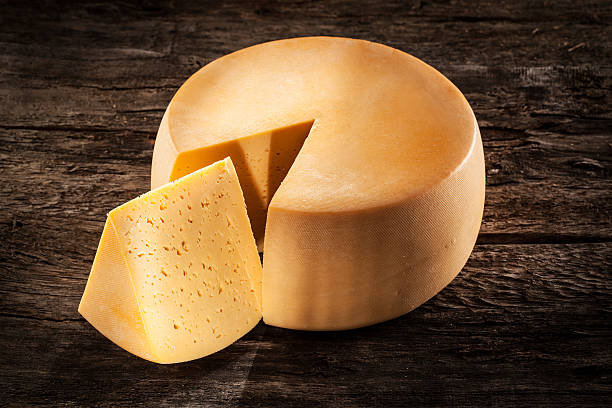 istock Cheese wheel on wood. Organic food 178482546