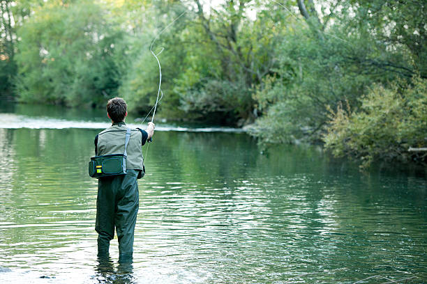 istock fisherman fishing on a river 178483795