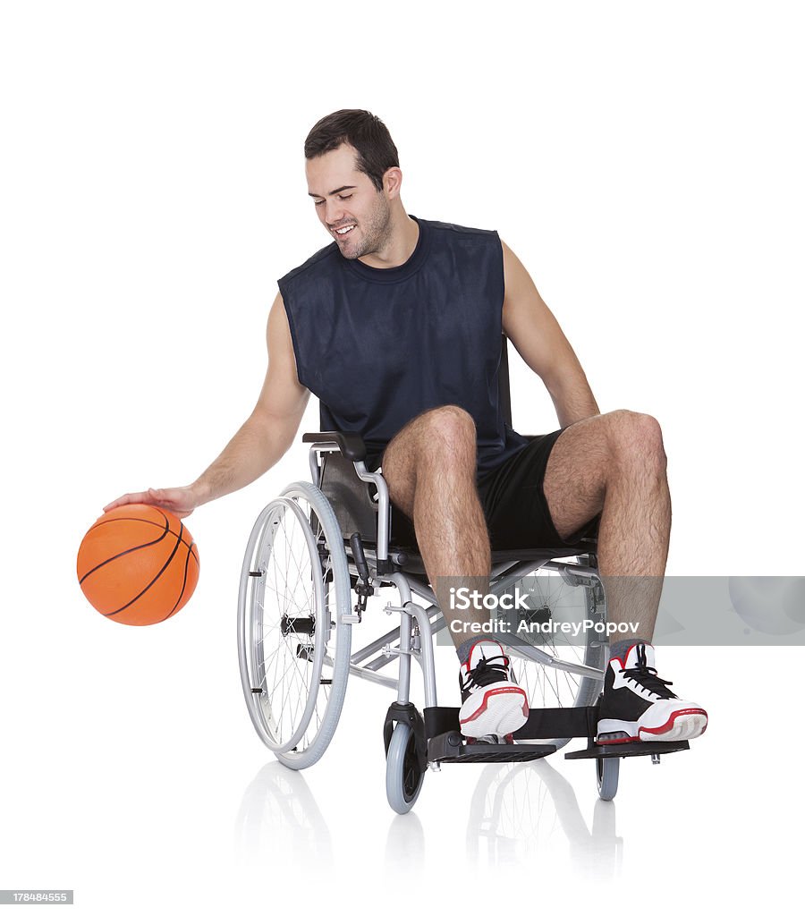 Man in wheelchair playing basketball Man in wheelchair playing basketball. Isolated on white Adult Stock Photo