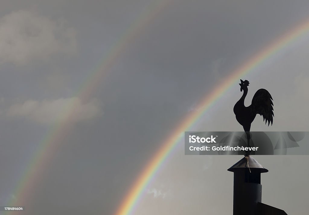 Cockerel weathervane against genuine double rainbow sky Hope, new day, dawn metaphor - or else just weather foecast! Allegory Painting Stock Photo