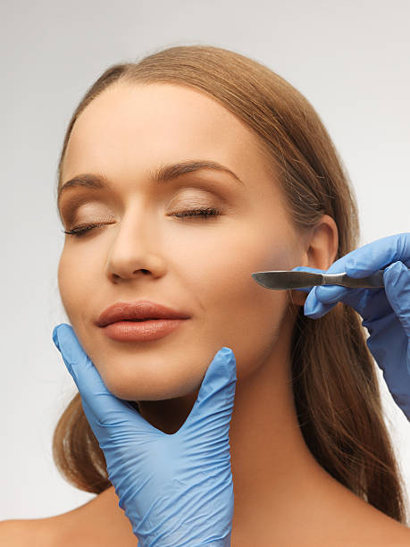 istock woman face and beautician hands 178485095