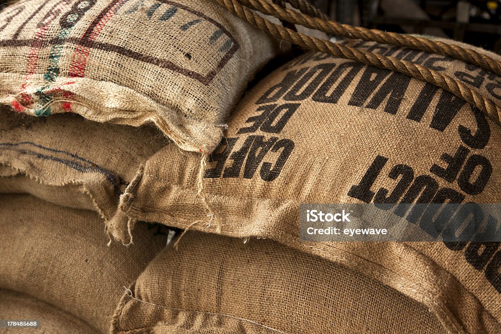 Burlap sacks with coffee beans stack of burlap sacks with coffee beans at warehouse Coffee Crop Stock Photo