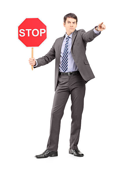 istock Man in suit holding a stop sign 178486008