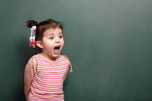 Excited Little Girl Excited Little Girl blackboard child shock screaming stock pictures, royalty-free photos & images