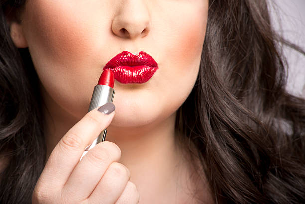 istock Brunette Woman Applies Red Lipstick 178486867