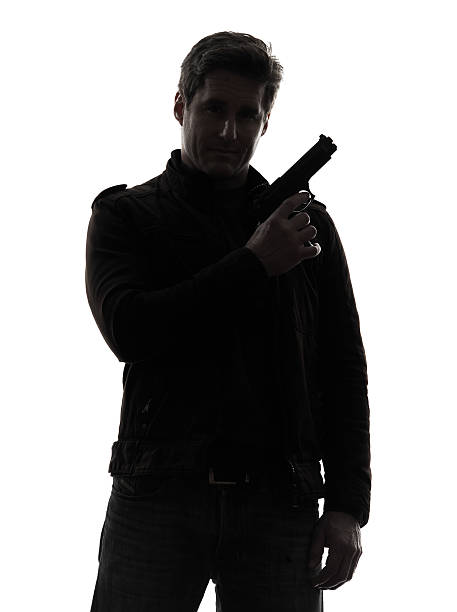 istock man killer policeman holding gun portrait silhouette 178487475