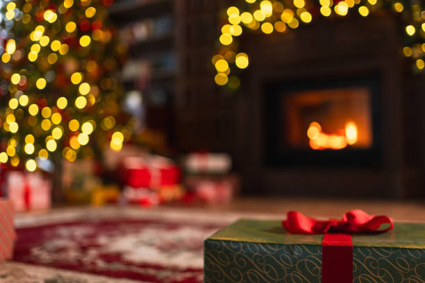 istock Classical Christmas decorated interior living room library with fireplace. Christmas tree with red golden ornament decorations. Modern classic style interior design apartment. Christmas eve at home. 1784876426