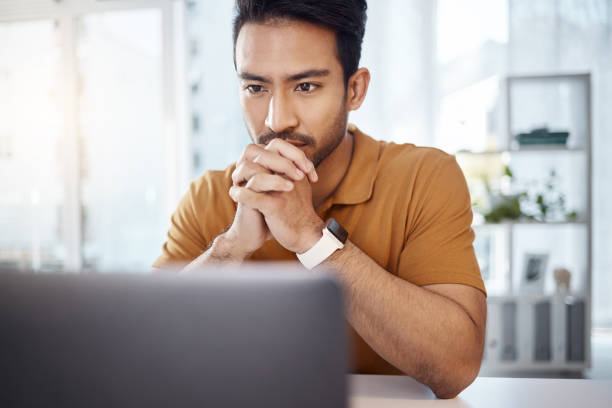 istock Laptop, business and Asian man with focus, thinking and ideas for new project, creativity or online reading. Male entrepreneur, professional or worker with technology, decision or choices for startup 1784879777