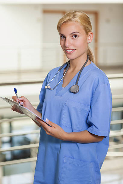 istock Blonde nurse writing on a clipboard 178488391