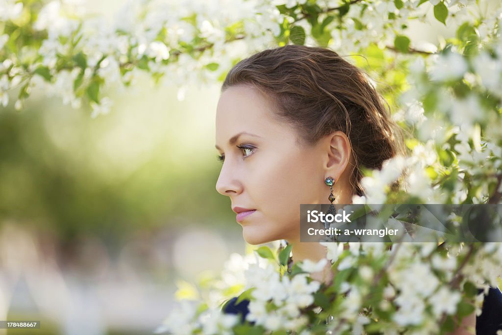 Beautiful woman in a spring garden other photos of this model: 30-34 Years Stock Photo