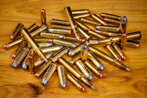 Different kinds of ammo on a wooden table