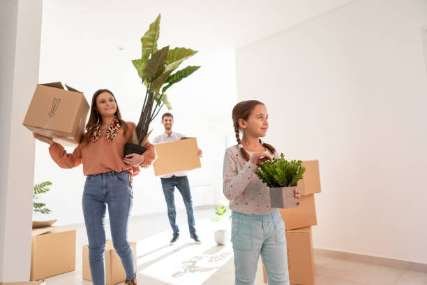 Young couple with daughter moving to their new home stock photo