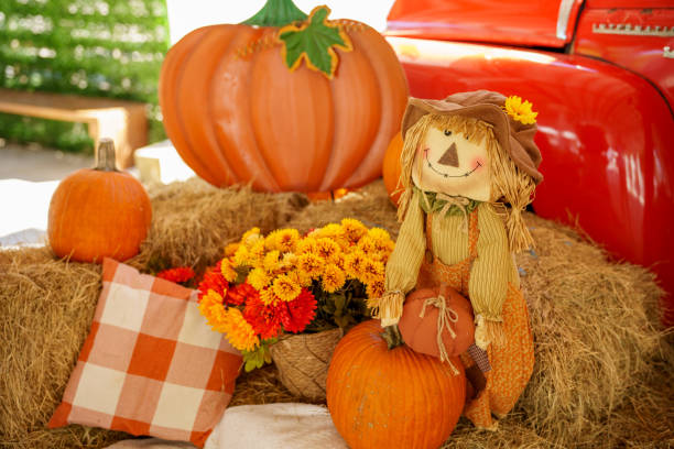 istock Festive fall farm scene with pumpkins and scarecrows 1784890021
