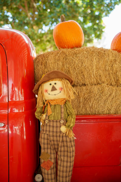 istock Festive fall farm scene with pumpkins and scarecrows 1784891053