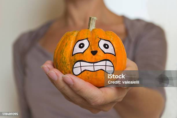 Woman Holds In Her Hand A Terrified Halloween Pumpkin Stock Photo - Download Image Now