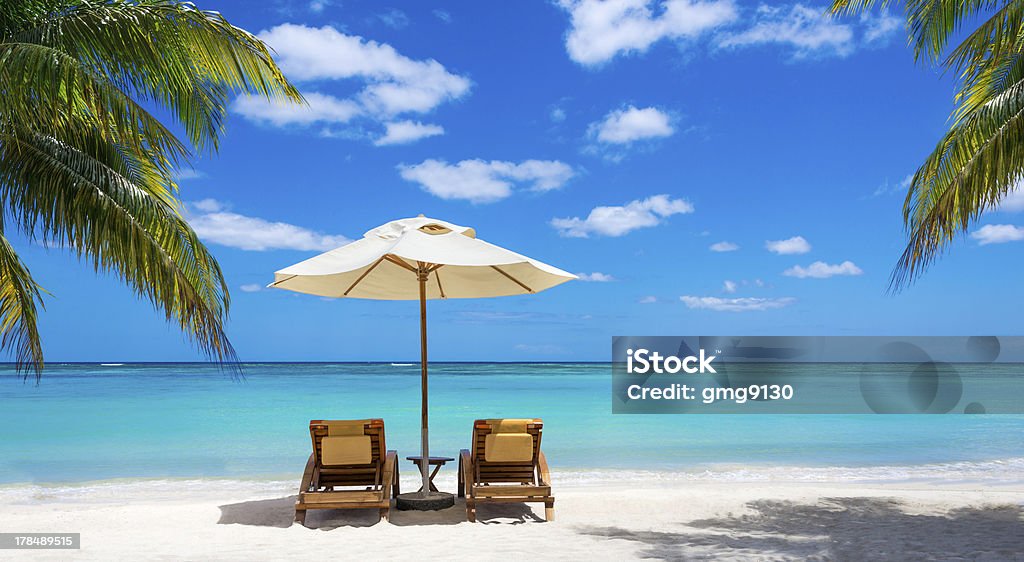 White sand and palm trees on beach turquoise sea, deckchairs, white sand and palms, sun, very beautiful nature Beach Stock Photo