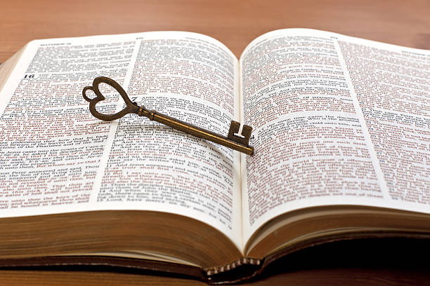 key on the Bible page stock photo
