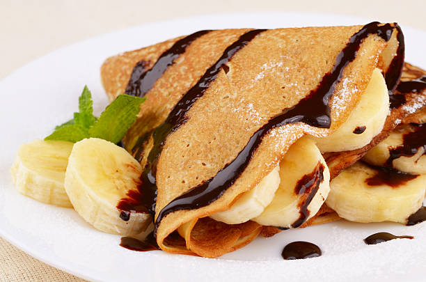 istock Freshly baked crepes with chocolate sauce and bananas 178489617