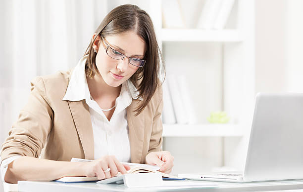 istock Young business women calculating while holding a document. 178490042