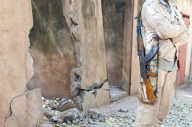 Black man stand with an AK 47 gun Malian soldier waiting with his weapon mali stock pictures, royalty-free photos & images
