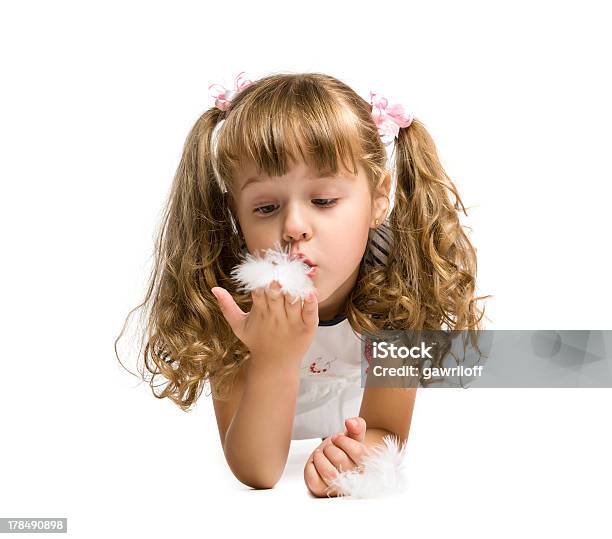 Little Girl Blowing On A Feather Stock Photo - Download Image Now - Activity, Aspirations, Baby - Human Age