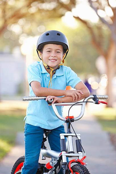 istock Boy Wearing Safety Helmet Riding Bike 178491072