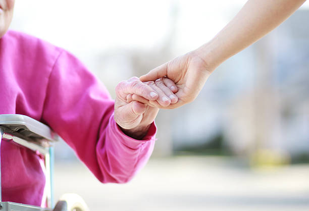 istock Senior Lady in Wheelchair Holding Hands 178491571
